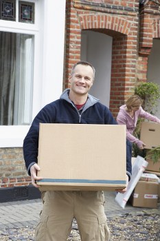 Stacked moving boxes and packing materials in Homerton