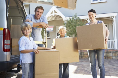 Trained movers handling boxes carefully during a relocation