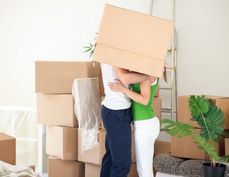Specialist movers using protective wrapping for a piano move