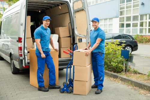 Man and van team handling boxes and household items in Homerton