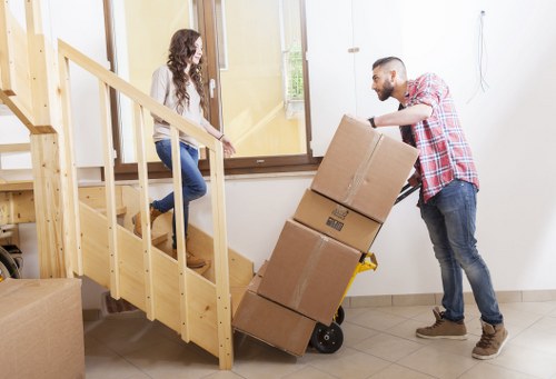 Office relocation team transporting desks and IT equipment